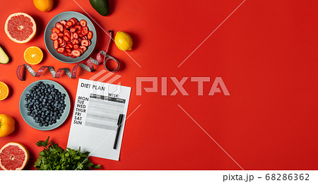 Diet plan and healthy food products on red background. Top view Copy space Banner. Diet plan and healthy food products on red background. Top view Copy space Banner. 68286362