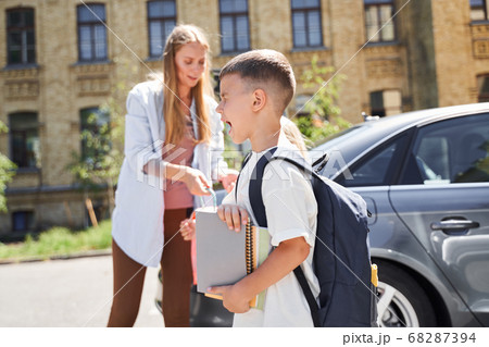 Cheerful boy with family on sunny day Cheerful boy with family on sunny day 68287394