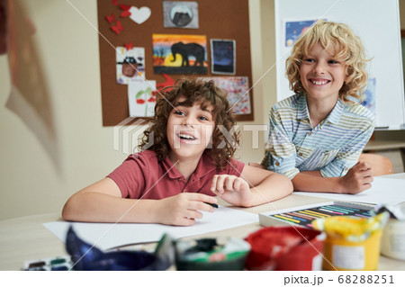 Happy boys enjoying painting classes at school Happy boys enjoying painting classes at school 68288251