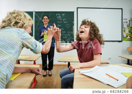 Jolly boys having fun during english lesson Jolly boys having fun during english lesson 68288266