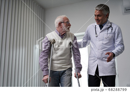 General practitioner taking a walk with his elderly patient General practitioner taking a walk with his elderly patient 68288799