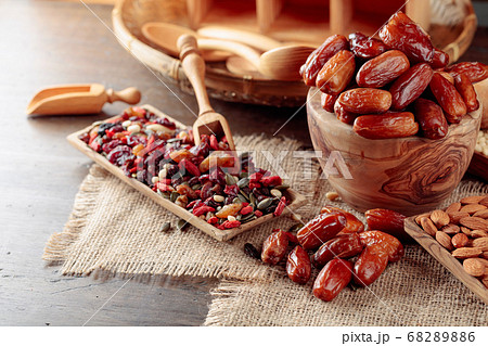 Dates and dried fruits on a old wooden table. 68289886