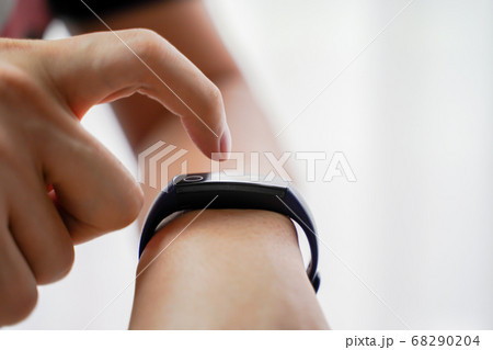 Close up hands of man using smartwatch with copy space. Black digital fitness wrist watch with finger 68290204
