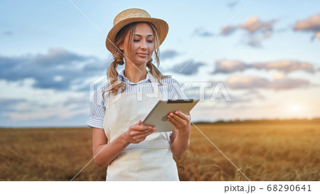 Woman farmer straw hat smart farming standing 68290641