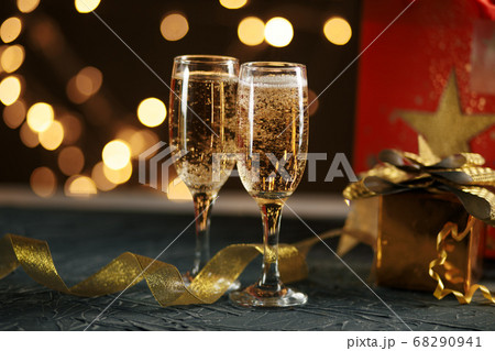 Ribbon, baubles and wine against Christmas lights 68290941