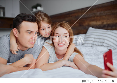 emotional happy family with daughter on bed 68291110