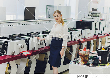 Young woman working in printing factory. Printing Press. 68292296