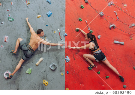 sportsman helping a sportswoman during rock climbing sportsman helping a sportswoman during rock climbing 68292490
