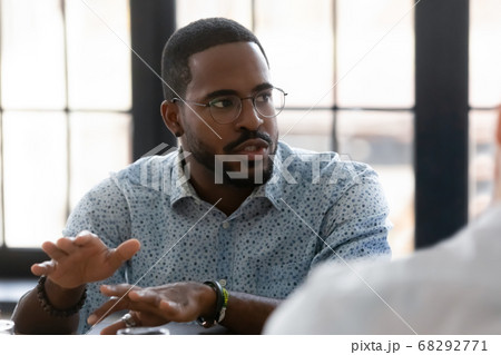 Close up confident African American businessman speaking at corporate meeting Close up confident African American businessman speaking at corporate meeting 68292771