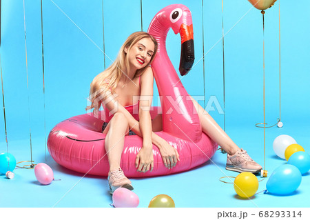awesome beautiful girl in trendy clothes sitting on the flamingo awesome beautiful girl in trendy clothes sitting on the flamingo 68293314