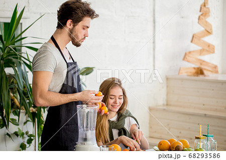 a couple making yogart with fruits a couple making yogart with fruits 68293586