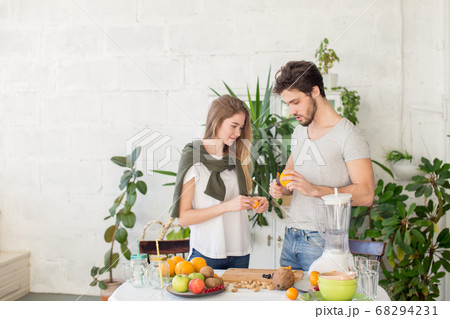 young pleasant man and woman learning to prepare a beverage 68294231