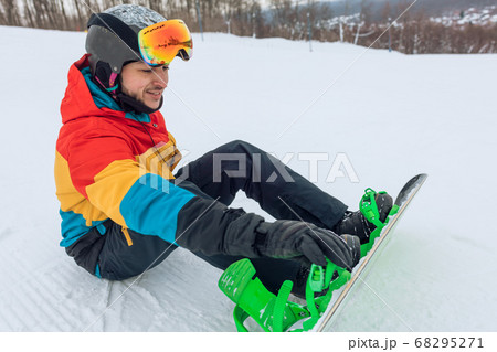 handsome positive man preparing for snowboarding 68295271