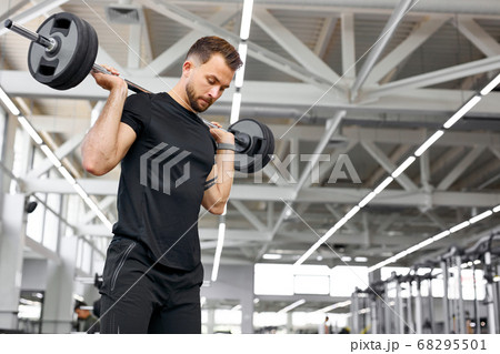 athletic caucasian bodybuilder working out, gaining weight pumping up muscles athletic caucasian bodybuilder working out, gaining weight pumping up muscles 68295501