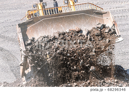 excavator bucket pours stones Mining industry, quarry equipment excavator bucket pours stones Mining industry, quarry equipment 68296346