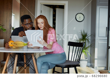 lovely diverse man and woman check documents 68296680