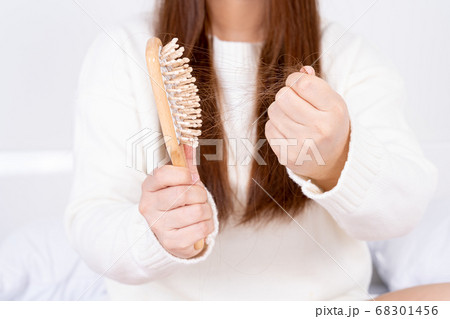 Hair fall problem, closeup hand holding comb and 68301456