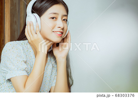 the woman is listening to music the woman is listening to music 68303376