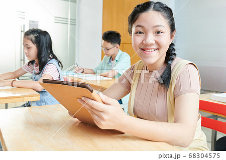 Schoolgirl with tablet computer 68304575