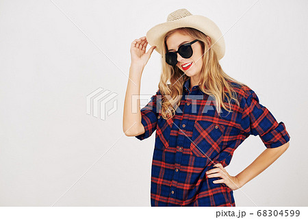 Woman in plaid shirt and hat 68304599