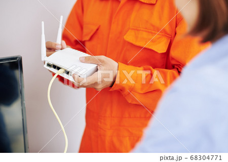 Electrician explaining how to use wi-fi router Electrician explaining how to use wi-fi router 68304771