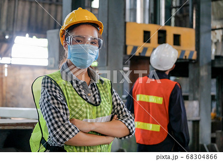 Factory woman engineer worker or technician with hygienic mask stand with confident action 68304866