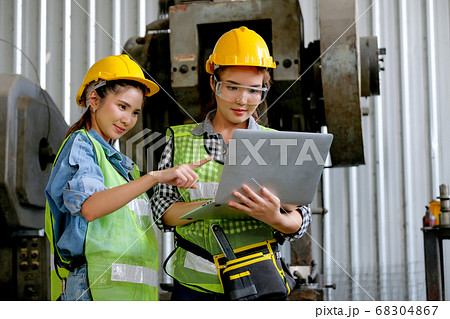 Factory worker women discuss together with laptop  in workplace area 68304867