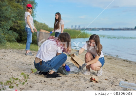 Group of students with teacher in nature doing cleaning of plastic garbage Group of students with teacher in nature doing cleaning of plastic garbage 68306038
