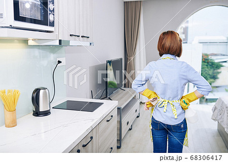 Housewife looking at clean apartment 68306417