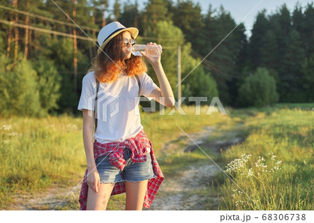 Beautiful teenager girl in hat with backpack bottle of fresh water 68306738