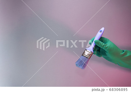 Beutiful Hand holding paint brush in the in neon 68306895
