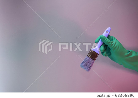 Beutiful Hand holding paint brush in the in neon Beutiful Hand holding paint brush in the in neon 68306896