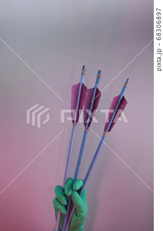 Beautiful hand holding old green arrows in the Beautiful hand holding old green arrows in the 68306897