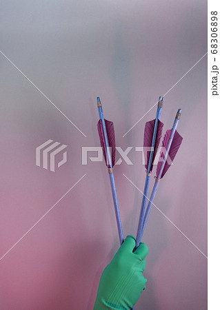 Beautiful hand holding old green arrows in the 68306898