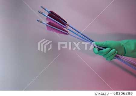 Beautiful hand holding old green arrows in the 68306899