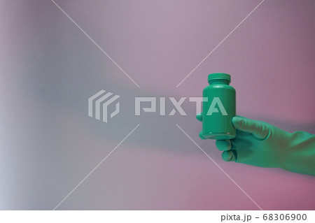 Beautiful hand hold Green bottle for pills in the 68306900