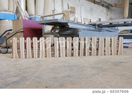Wooden rustic style fence in carpentry workshop, woodworking machinery background 68307606
