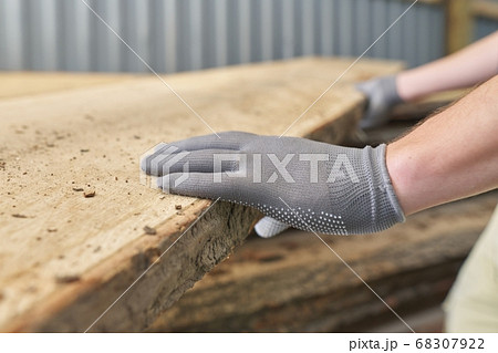 Carpenters hands with plank wood at carpentry woodworking workshop 68307922
