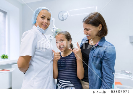 Happy mother and child in office with dentist doctor after dental treatment Happy mother and child in office with dentist doctor after dental treatment 68307975