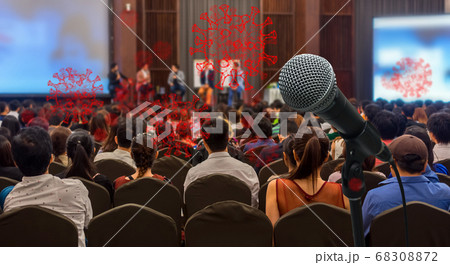 Coronavirus Network Outbreak over Rear view of Audience listening Speakers on the stage in the conference hall or seminar meeting, business and education take risk for covid19, social distance concept 68308872