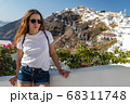 Happy smiling woman tourist traveling on luxury cruise in Mediterranean, Greece, Santorini. Background architecture island sea sky 68311748