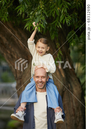 Cheerful Kid Riding on Fathers Shoulders 68312690