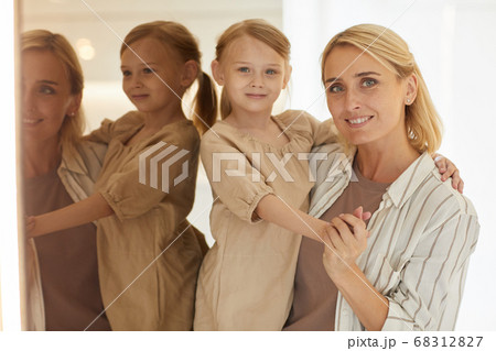 Modern Woman Holding Little Girl 68312827