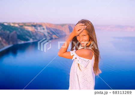 Little girl on top of a mountain enjoying valley view before sunset 68313269