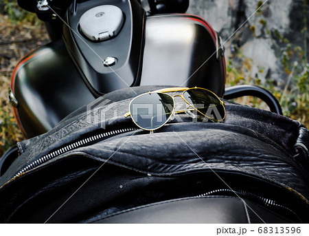 sunglasses on a leather jacket on a motorcycle sunglasses on a leather jacket on a motorcycle 68313596