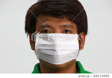 Masked Asian man prevent germs. Tiny Particle or virus corona or Covid 19 protection. Masked Asian man prevent germs. Tiny Particle or virus corona or Covid 19 protection. 68313660