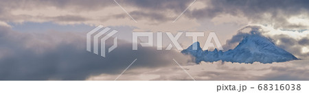 Foggy clouds, mountain top and sun glow in evening Foggy clouds, mountain top and sun glow in evening 68316038
