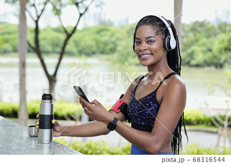 Sportswoman checking phone Sportswoman checking phone 68316544