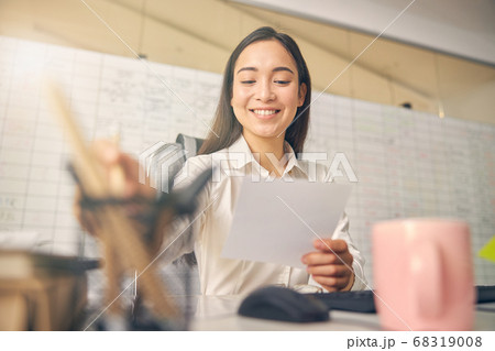 Portrait of longhaired woman while reading notes Portrait of longhaired woman while reading notes 68319008
