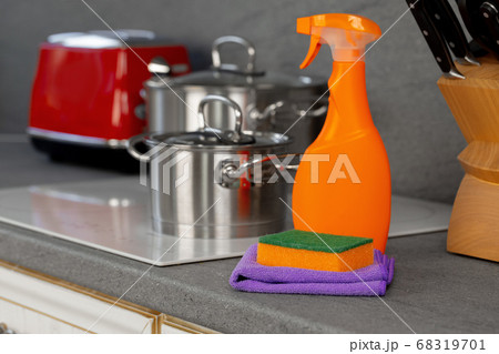 Cleaning detergents and tools on a kitchen counter 68319701